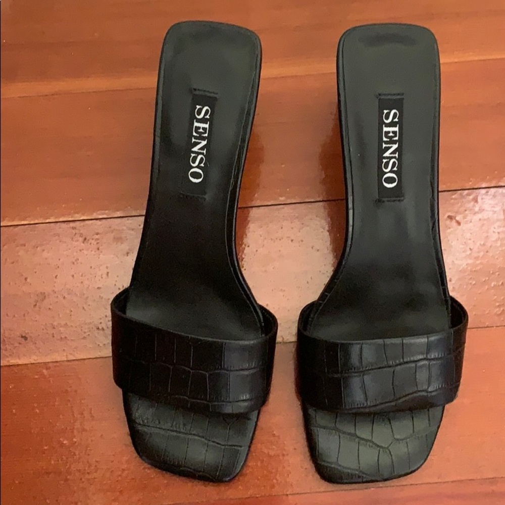 Black embossed leather low heel slides